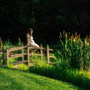 woman sitting on bridge