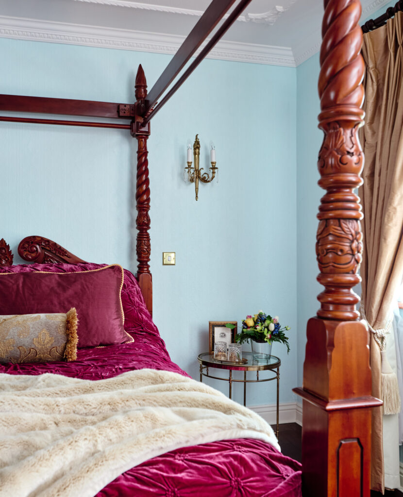 bedroom with a four poster bed detail of side table